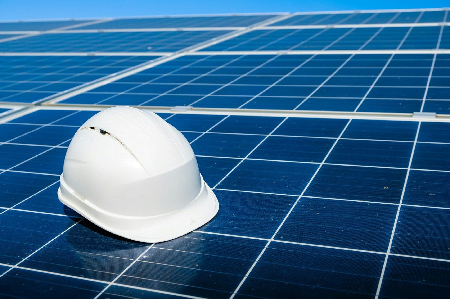 A safety helmet placed on solar panels for a renewable energy business